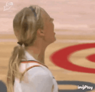 Woman In Ponytail Looking Up On Basketball Court GIF