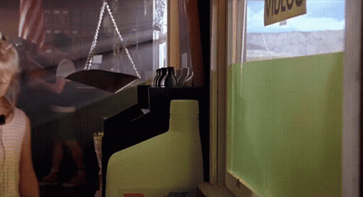 Woman In Ponytail Stands In Front Of Group In Restaurant GIF