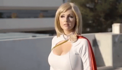 Woman In Power Girl Costume On Rooftop GIF