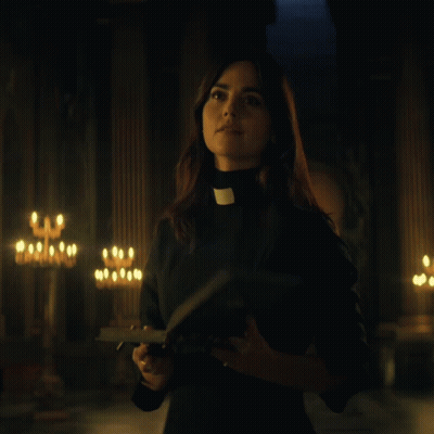 Woman In Priest Collar Holding Bible GIF