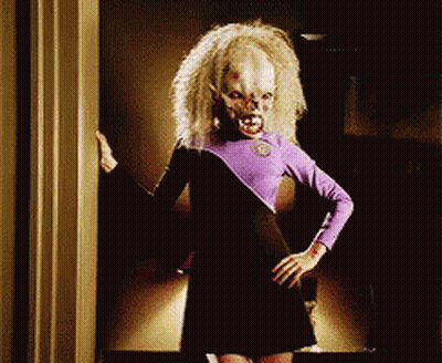 Woman In Purple And Black Dress In Doorway Hands On Hips GIF