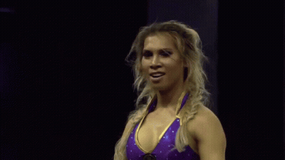 Woman In Purple And Gold Wrestling Outfit Waving GIF