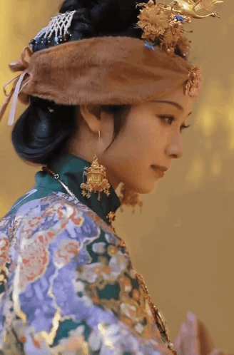 Woman In Purple And Green Dress And Earrings GIF