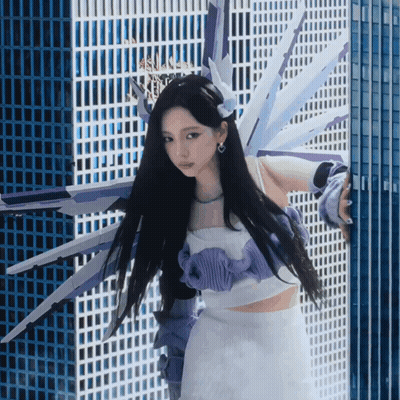 Woman In Purple And White Outfit By Building GIF