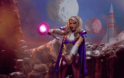 Woman In Purple Cape Holding Purple Object GIF