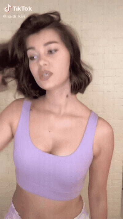 Woman In Purple Crop Top Making Funny Face GIF