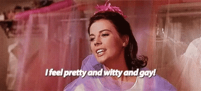 Woman In Purple Dress And Pink Headband Saying I Feel Pretty And Witty And Gay GIF
