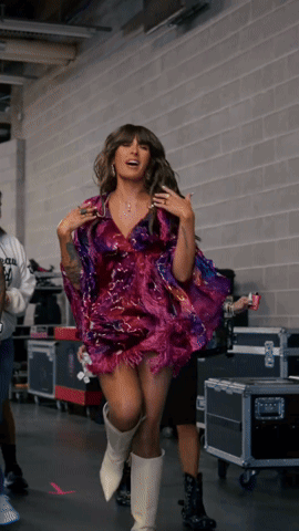 Woman In Purple Dress And White Boots In Hallway GIF