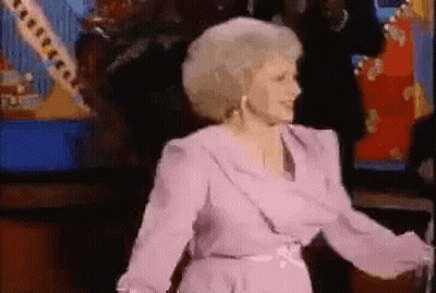 Woman In Purple Dress Dancing In Front Of Crowd GIF