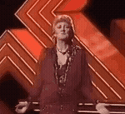 Woman In Purple Dress Dancing On Stage GIF