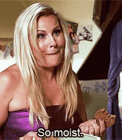 Woman In Purple Dress Holding Food Saying So Moist GIF
