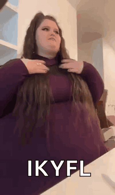 Woman In Purple Dress Holding Hair GIF