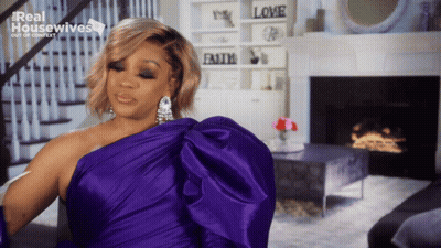 Woman In Purple Dress In Front Of Fireplace Real Housewives GIF
