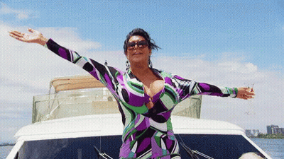 Woman In Purple Dress On Boat With Arms Outstretched GIF