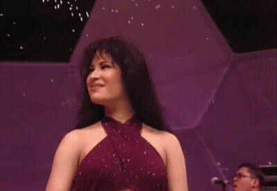 Woman In Purple Dress On Stage With Piano Player GIF