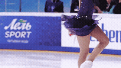 Woman In Purple Dress Skating In Front Of Aerb Sport Sign GIF