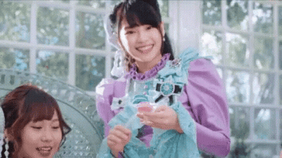 Woman In Purple Dress Smiling Holding Glass GIF