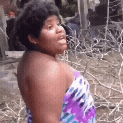 Woman In Purple Dress Standing Before Branches GIF