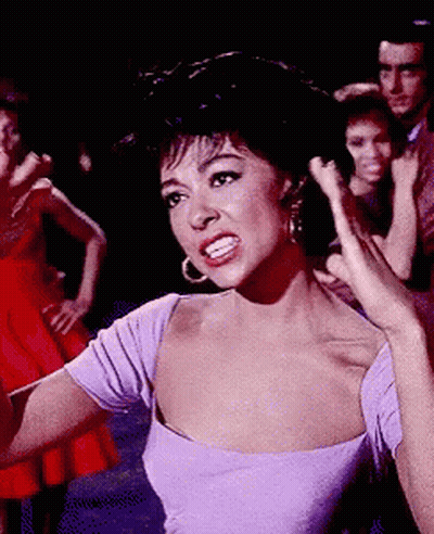Woman In Purple Dress Standing Before Group GIF