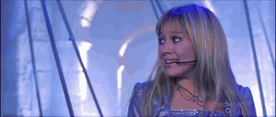 Woman In Purple Dress With Microphone On Ear GIF