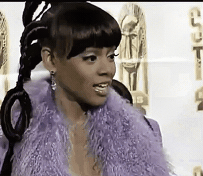 Woman In Purple Fur Coat And Earrings GIF