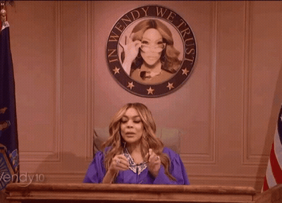 Woman In Purple Gown At Podium With Seal Saying In Wendy We Trust GIF