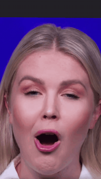 Woman In Purple Jacket And Necklace At Microphone GIF