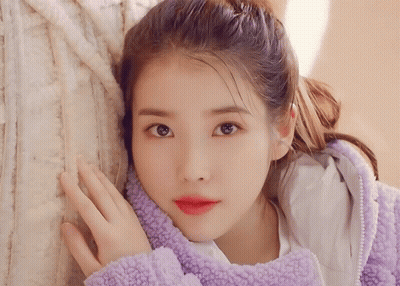 Woman In Purple Jacket Hand On Face GIF