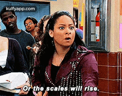 Woman In Purple Jacket Holding Box And Book In Line GIF