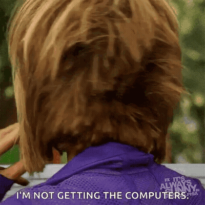 Woman In Purple Jacket Holding Hair In Bun GIF