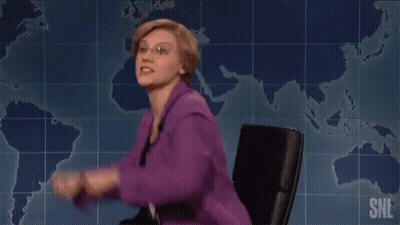 Woman In Purple Jacket Next To Man In Suit And Tie On SNL GIF