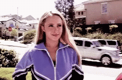 Woman In Purple Jacket Walking Down Street GIF