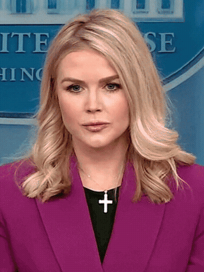 Woman In Purple Jacket With Cross Necklace GIF