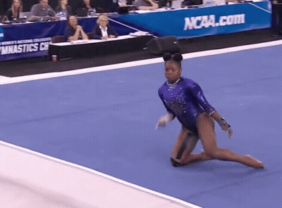 Woman In Purple Leotard Doing Trick In Front Of NCAA.com Sign GIF