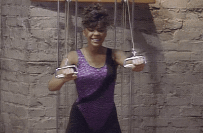 Woman In Purple Leotard Holding Pulleys GIF