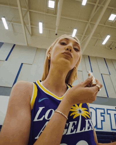 Woman In Purple Los Angeles Jersey Looking Down GIF