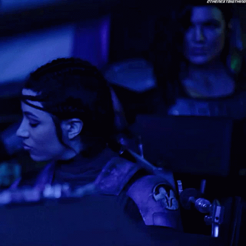 Woman In Purple Outfit Sitting In Dark Room GIF