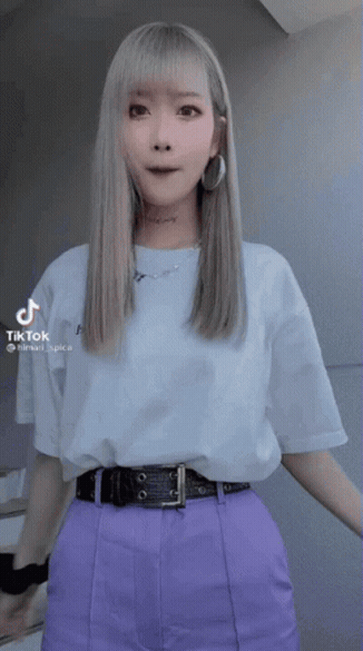 Woman In Purple Pants And White T-Shirt With TikTok Sticker GIF