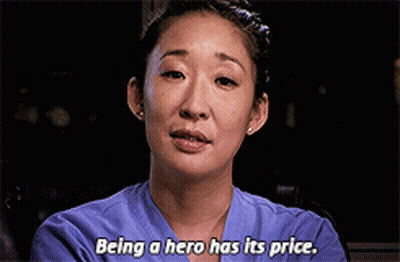 Woman In Purple Scrub Top Saying Being A Hero Has Its Price GIF