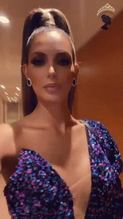 Woman In Purple Sequined Dress Taking Selfie GIF