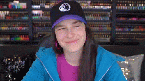 Woman In Purple Shirt And Black Hat With Smiley Face GIF