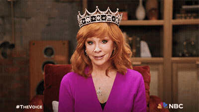 Woman in Purple Shirt and Tiara With NBC Logo