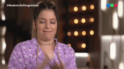 Woman In Purple Shirt Applauding In Front Of Masterchef Argentina Screen GIF