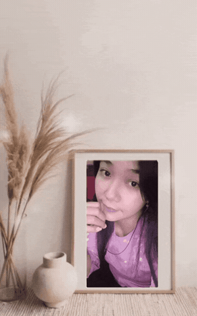 Woman In Purple Shirt Framed Next To Vase GIF