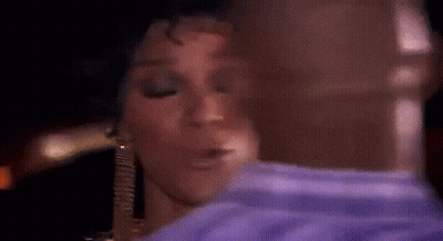 Woman In Purple Shirt Kissing Man In Blue Shirt GIF