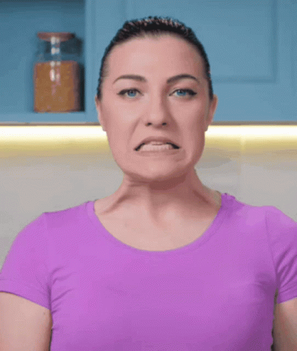 Woman In Purple Shirt Making Face GIF
