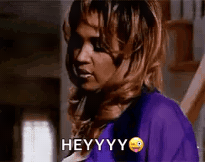 Woman In Purple Shirt Making Funny Face Saying Hey GIF