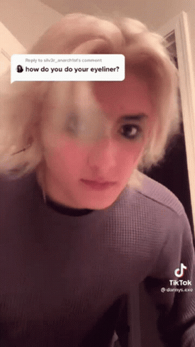 Woman In Purple Shirt Questioning Eyeliner GIF