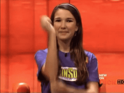 Woman In Purple Shirt Raising Arm GIF