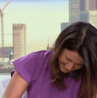 Woman In Purple Shirt Smiling With City Skyline GIF